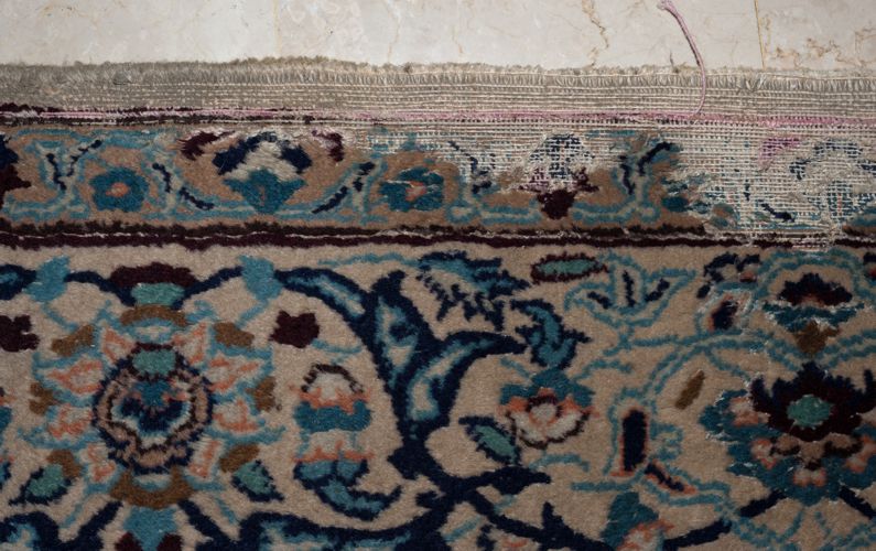 Moth damage to a Nain rug