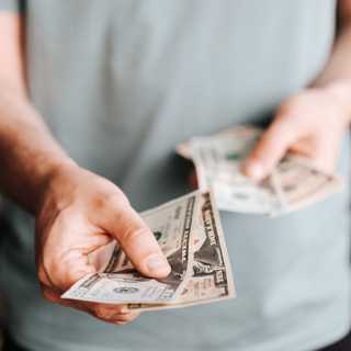 Man handing out cash